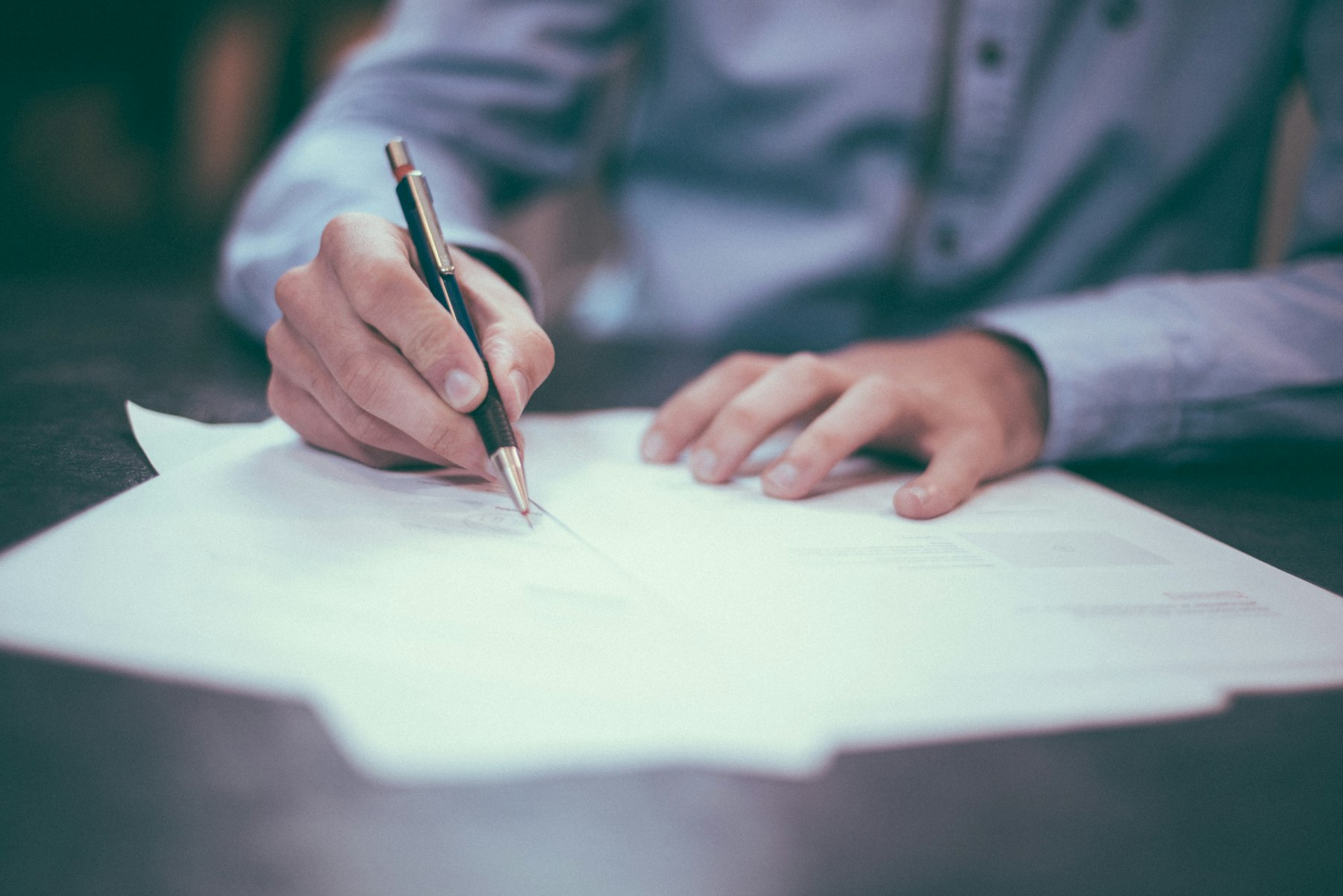 A professional working through documents at a desk
